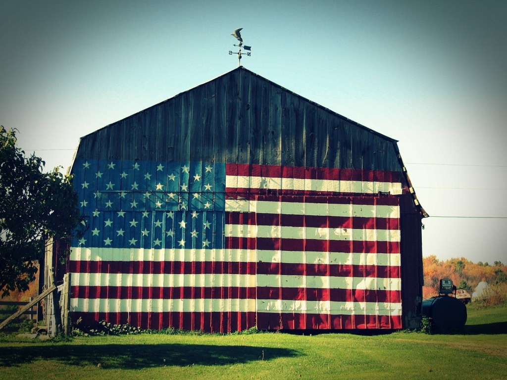 vintage barn with flag on its outside wall