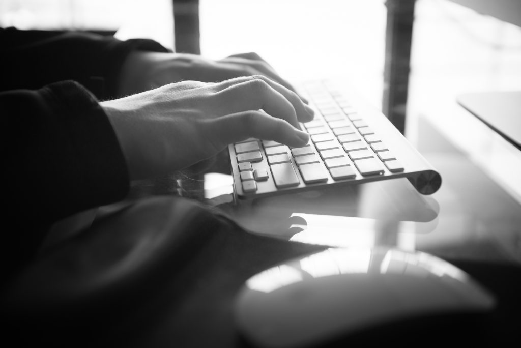 photos of hands typing at a keyboard on a desk