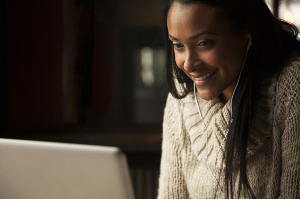 Church software technician with a head set listening through her computer to a support question from a user that is using a FASB compliant church fund accounting software.