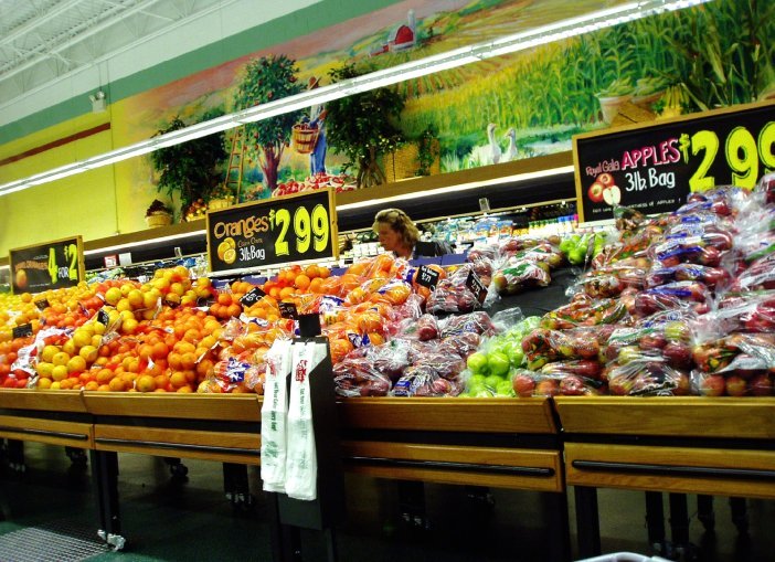 picture of a grocery produce isle which is symbolic of a consumer or producer type of person