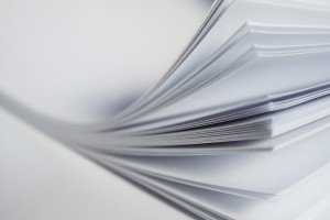 stack of paper with corner of the pages turned up