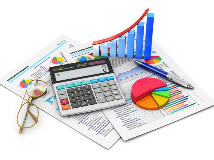 Calculator, pen and glasses on top of reports with 3D pie chart and bar graph