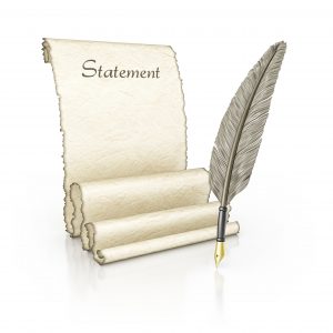 feather quill ink pen and parchment scroll unraveled with 'Statement' written at the top