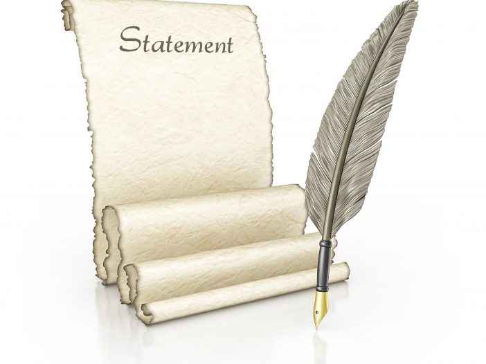 feather quill ink pen and parchment scroll unraveled with 'Statement' written at the top
