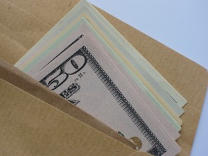 envelope with money coming out resembling a church's receipt of donations