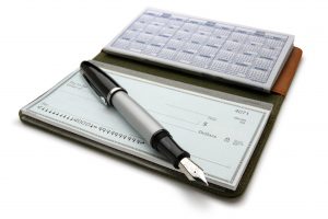 An open checkbook and pen. Clipping path included.