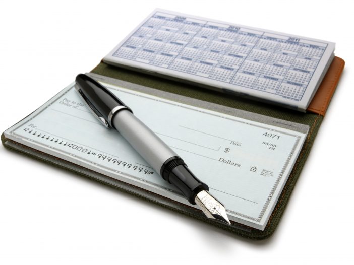 An open checkbook and pen. Clipping path included.