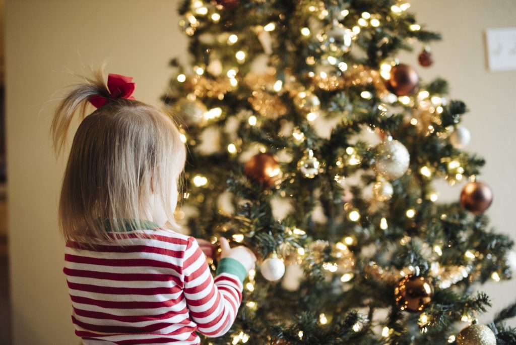 little girl in front of Christmas Tree
