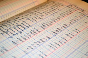 Old paper style church accounting ledger that shows numbers on each line along with the names that money went too.