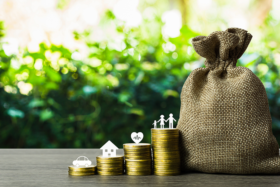 Stack of coins and bag of money. Each stack of coins represents a different area of the household budget like car, house, health, family time which is just like fund accounting.