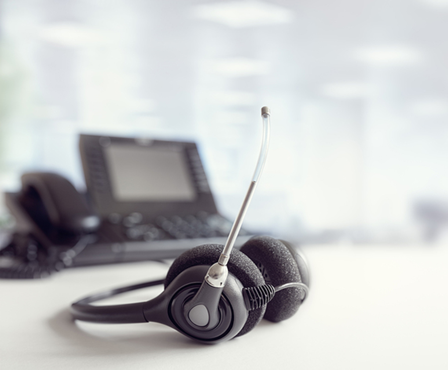 Phone with headphone attachment for webinar support. Phone and headphone set which shows the equipment used during a sales and training webinar.