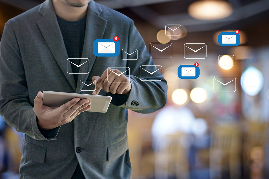 A person on a tablet sending email communication to their church members.