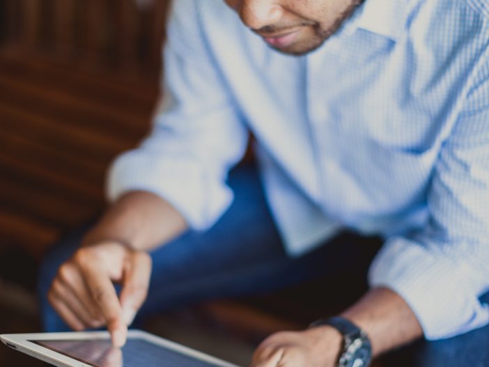 A gentleman using a tablet for his church software