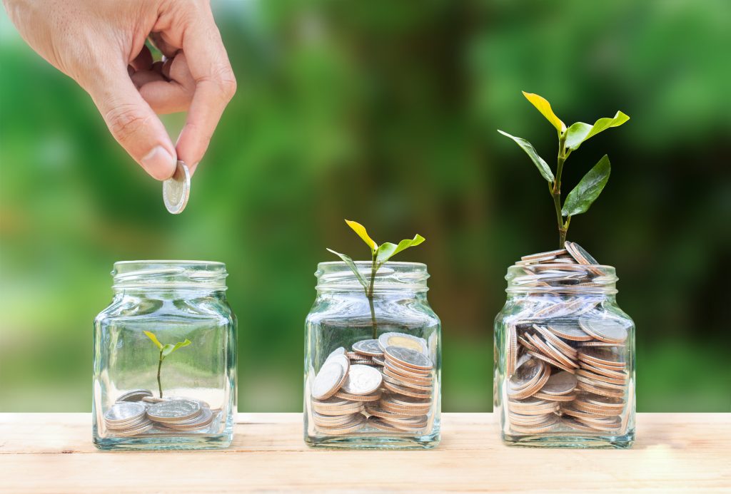 Three jars filled with money at various levels which represent different church funds.